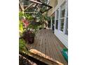Spacious wooden deck with lush plants and garden views provides a relaxing outdoor space at 715 Riverside Dr, Tarpon Springs, FL 34689