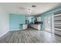 Open dining area with modern light fixture and slider doors to outside at 739 Chesapeake Dr, Tarpon Springs, FL 34689