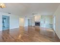 Spacious living room with hardwood floors, a cozy fireplace, and built-in shelving at 739 Chesapeake Dr, Tarpon Springs, FL 34689