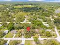 Expansive aerial view showcasing the home's location within a lush, tree-filled neighborhood at 8268 Garrison St, Spring Hill, FL 34606