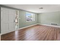 Spacious living room features a window for natural light, new floors, and a freshly painted interior at 10039 Old Hickory Ln, Port Richey, FL 34668