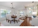 Open-concept living and dining area showcasing wood floors, modern furnishings, and ample natural light at 10364 Lightner Bridge Dr, Tampa, FL 33626