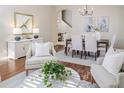 Cozy living room with elegant furnishings, wood floors, and seamless transition to the dining area at 10364 Lightner Bridge Dr, Tampa, FL 33626