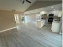 Open-concept living space with updated flooring, modern kitchen, and lots of natural light at 10999 Del Prado E Dr, Largo, FL 33774