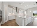 Modern, spacious kitchen with white cabinets, stainless steel appliances, and a large island at 11622 Gleaming Ter, Venice, FL 34293
