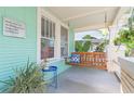 Charming front porch featuring a classic swing, perfect for relaxing and enjoying the outdoors at 1202 E Mohawk Ave, Tampa, FL 33604