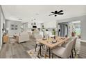 Open-concept living space blending dining, living and kitchen areas, enhanced with modern decor and new lighting at 1223 Jasmine Way, Clearwater, FL 33756