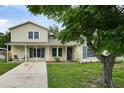 Charming home with well-manicured lawn, complemented by a beautiful tree and a welcoming entrance at 1305 Willow Valley Dr, Brandon, FL 33510