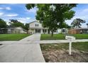 Traditional home featuring a well-kept lawn, complemented by a mailbox, tree, and a quaint front porch at 1305 Willow Valley Dr, Brandon, FL 33510