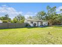 View of the home showcasing the front yard and the home's exterior at 1601 Paloma Ln, Dunedin, FL 34698
