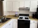 Functional kitchen features an efficient layout with sleek appliances and practical cabinetry at 1605 Mission Hills Blvd # D5, Clearwater, FL 33759
