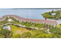 Aerial view of waterfront townhomes with community pool overlooking the water at 163 Brent Cir, Oldsmar, FL 34677