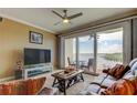 Cozy living room featuring water views, comfortable seating, and a ceiling fan at 163 Brent Cir, Oldsmar, FL 34677