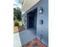 Eye-level view of a townhome entryway with a dark blue door, mailbox, and exterior light fixture at 1935 Oxnard Ct, Tampa, FL 33612