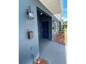 Close-up of townhome entrance, highlighting the dark blue front door, mailbox, and house number at 1935 Oxnard Ct, Tampa, FL 33612