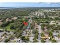 An aerial shot of a neighborhood showcasing the property's location amongst lush greenery and nearby amenities at 1949 Kings Hwy, Clearwater, FL 33755