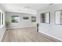 Bright, open living room with modern floors and natural light from large windows at 201 83Rd N Ave, St Petersburg, FL 33702