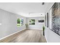 Inviting living room boasts hardwood floors, abundant natural light, and neutral decor at 201 83Rd N Ave, St Petersburg, FL 33702