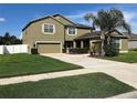 Two-story home with well-maintained lawn, desert landscaping, and a two-car garage plus a one-car garage at 20101 Oakflower Ave, Tampa, FL 33647
