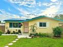 Attractive single-story home with solar panels, well-maintained lawn, and colorful landscaping at 2707 56Th S St, Gulfport, FL 33707