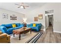 Cozy living room with plush blue sofas, a wooden coffee table, and neutral decor at 3113 Chamblee Ln, Clearwater, FL 33759