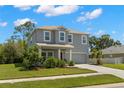 Charming two-story home with manicured lawn, mature landscaping, and a two-car garage at 3115 Gina Ct, Holiday, FL 34691