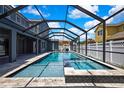 Stunning backyard pool and spa area with a screened enclosure and ample space at 3241 Evening Breeze Loop, Wesley Chapel, FL 33544