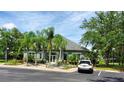 Exterior shot of community center, showcasing ample parking and lush landscaping at 3493 Kings Rd # 106, Palm Harbor, FL 34685