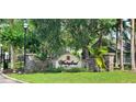 Stone entrance sign for Waterford Condominium Residences in a landscaped setting at 3493 Kings Rd # 106, Palm Harbor, FL 34685