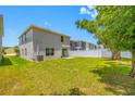Well-maintained backyard with a lush green lawn and a sturdy privacy fence, perfect for outdoor activities and relaxation at 36652 N Spanish Rose Dr, Dade City, FL 33525