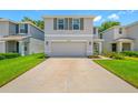 Charming home featuring a two-car garage, beautiful landscaping, and a welcoming front porch at 36652 N Spanish Rose Dr, Dade City, FL 33525
