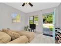 Open view from living room to front yard with large sofa and lots of natural light at 3714 N Garrison St, Tampa, FL 33619