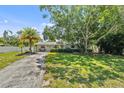 Inviting single-story home boasts mature trees, a well-kept lawn, and an attractive front facade at 4530 Catalonia S Way, St Petersburg, FL 33712