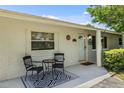Cozy front porch area with seating, a decorative rug, and an inviting entrance enhances the home's charm at 4530 Catalonia S Way, St Petersburg, FL 33712