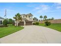 Beautiful two-story home with a well-manicured lawn, three-car garage, and a charming second-story balcony at 4607 Los Robles Ct, Palmetto, FL 34221