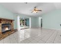 Open living room featuring tile floors, a stone fireplace, and sliding doors to the pool at 5112 Odin St, Spring Hill, FL 34608
