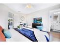 Bedroom features sleek furniture, a mounted TV, and access to the bathroom and seating area at 5730 Imperial Ky, Tampa, FL 33615