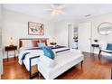 Bedroom featuring stylish decor, wood flooring, a ceiling fan and a luxurious upholstered bench at 5730 Imperial Ky, Tampa, FL 33615