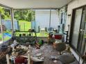 Enclosed porch with screen and windows, needing cleaning and renovation, showcasing outdoor potential at 8109 Franklin Rd, Plant City, FL 33565