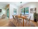 Bright dining room features light wood floors, a modern light fixture, and windows with outdoor views at 1015 W Charter St, Tampa, FL 33602