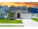 Charming two-story home featuring stone accents, a well-manicured lawn, and a two-car garage at 1015 W Charter St, Tampa, FL 33602