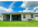 Green backyard showcasing the home's screened lanai and privacy, offering an outdoor retreat at 10621 Scenic Hollow Dr, Riverview, FL 33578