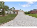 A charming one-story home featuring a two car garage and a brick paved driveway at 11251 Pickford St, Spring Hill, FL 34609