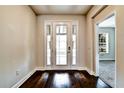 Light-filled entryway with hardwood floors and a view into another room at 11613 Sweet Tangerine Ln, Tampa, FL 33626