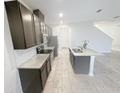 Modern kitchen with granite countertops, stainless steel appliances and a large kitchen island at 11634 Woodleaf Dr, Bradenton, FL 34211