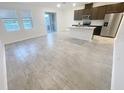 Bright, open-concept living space featuring tile flooring, lots of windows and modern finishes throughout at 11634 Woodleaf Dr, Bradenton, FL 34211