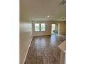 Bright living room with tile floors and sliding doors leading to a water view at 11634 Woodleaf Dr, Bradenton, FL 34211