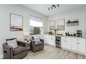 Bright, modern bar with white cabinets, granite counters, a beverage cooler, and stylish decor at 11837 Derbyshire Dr, Tampa, FL 33626