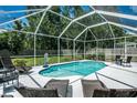 Enjoy the outdoors with a private screened-in pool and patio area, perfect for relaxation and entertaining at 11837 Derbyshire Dr, Tampa, FL 33626