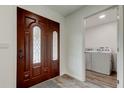 Elegant front door with decorative glass, leading to a view of the laundry area at 13344 88Th Ave, Seminole, FL 33776